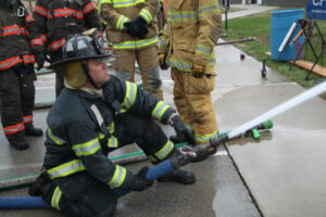 Firefighter on a line at FDIC 2014.